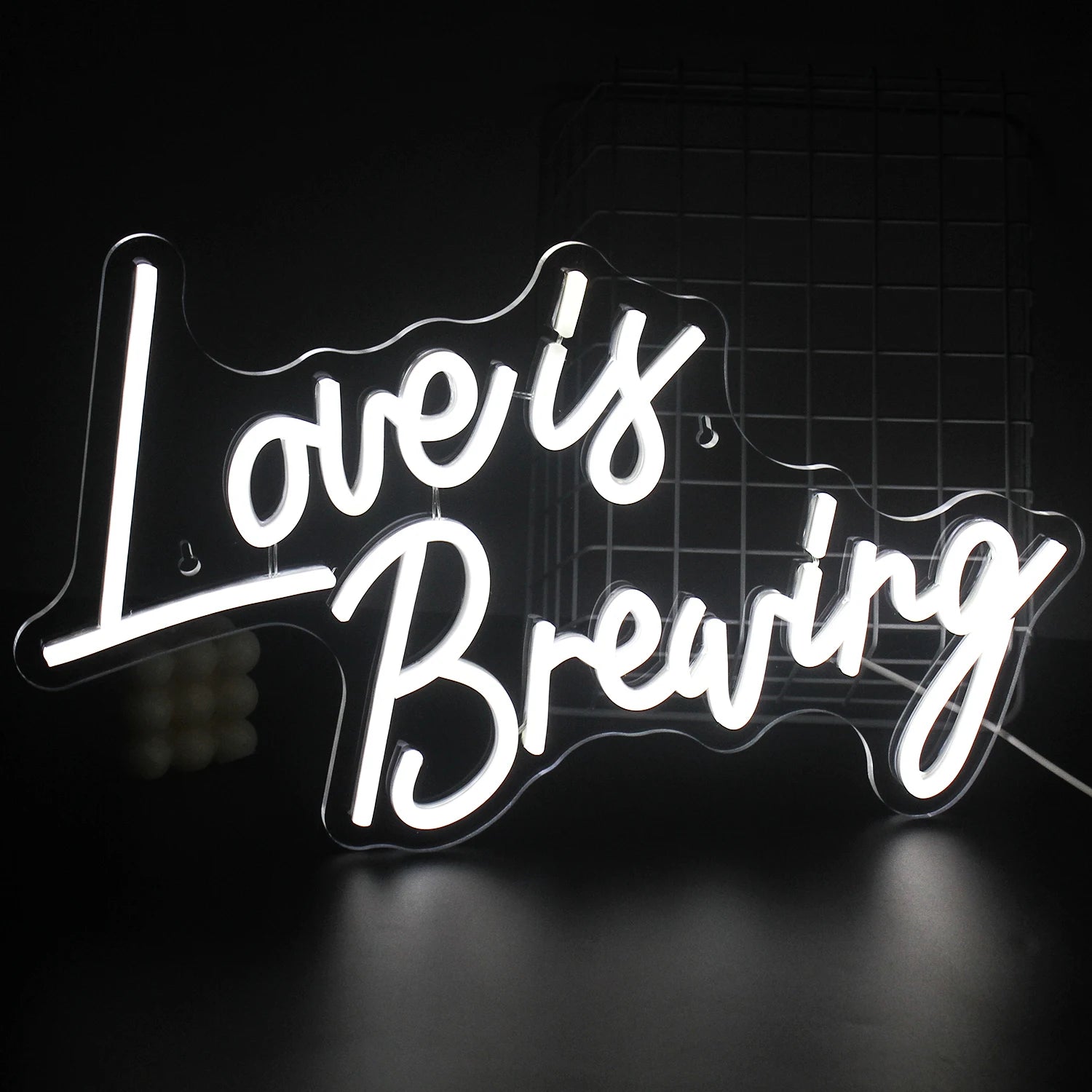A vibrant LED neon sign displaying the phrase "Love is Breaking," featuring bold, modern typography.