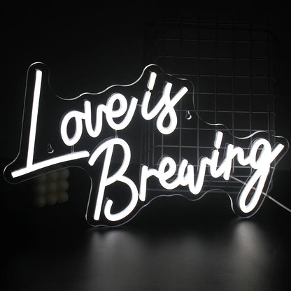 A vibrant LED neon sign displaying the phrase "Love is Breaking," featuring bold, modern typography.