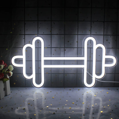 A vibrant LED neon sign shaped like a barbell, glowing in a striking combination of bright colors.