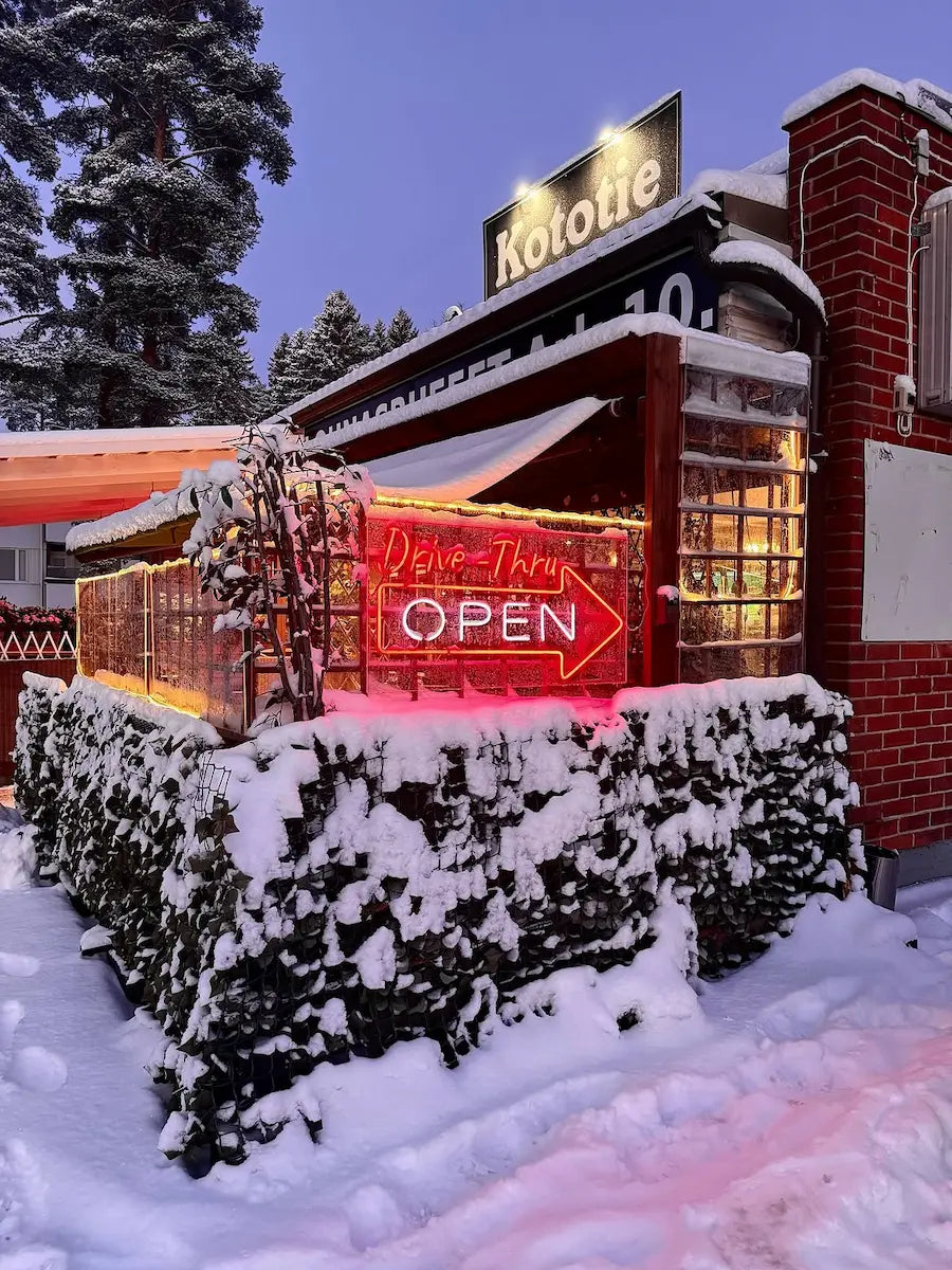 Red outdoor Drive-Thru OPEN LED neon sign at Kototie restaurant in snowy Seinäjoki