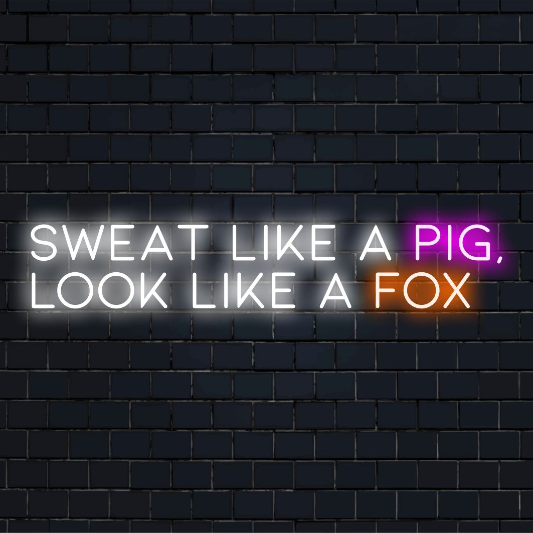Een LED-neonbord met de tekst Sweat Like A Pig, Look Like A Fox, een combinatie van motiverende kunst en stijlvolle lichtdecoratie.