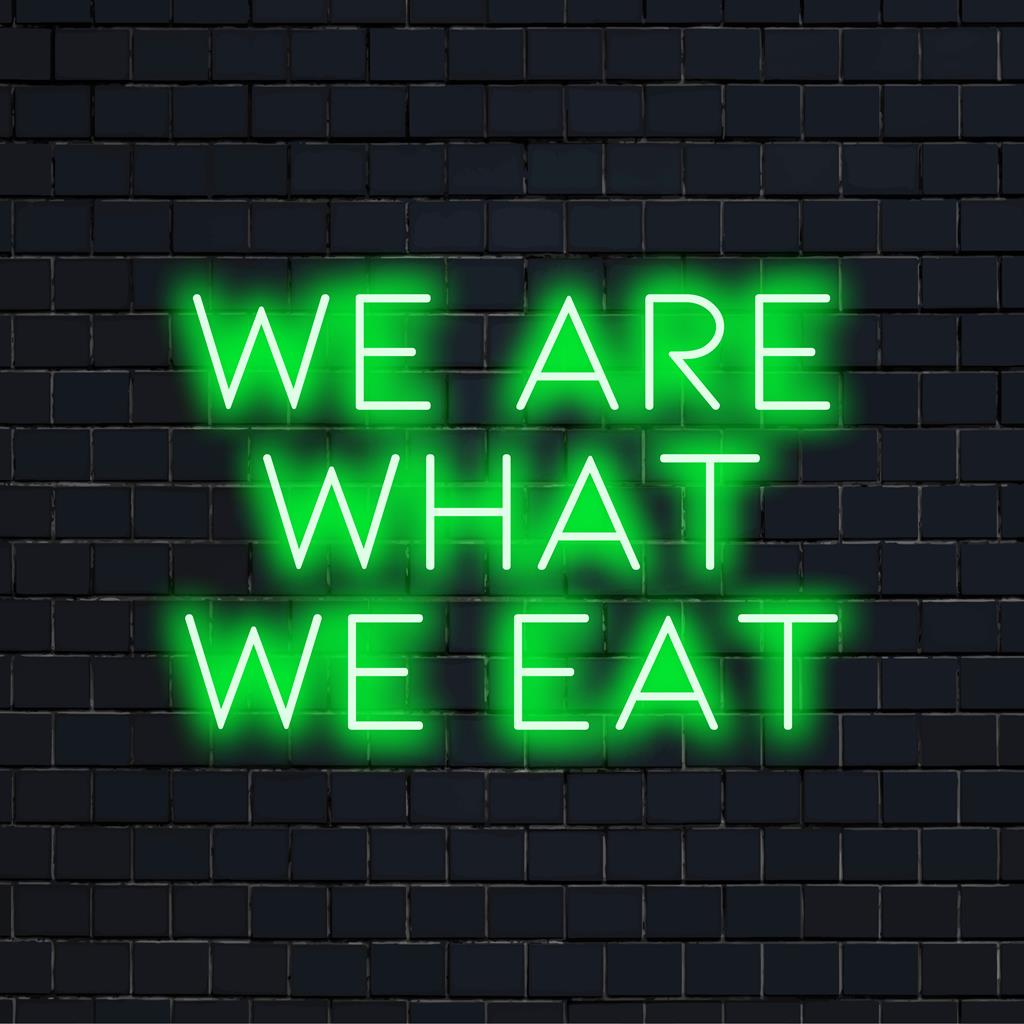 LED neon sign displaying We Are What We Eat, showcasing bright aesthetic neon light art perfect for modern decor.