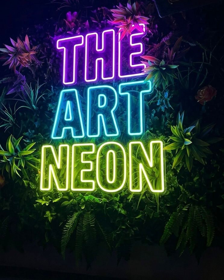 Multicolour The Art Neon LED neon sign displayed among plants
