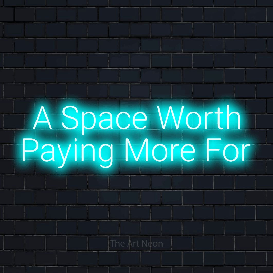 "A Space Worth Paying More For" text design with neon effect on a black brick wall