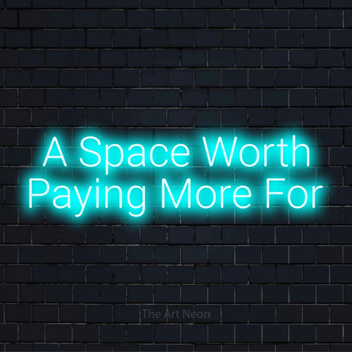 "A Space Worth Paying More For" text design with neon effect on a black brick wall