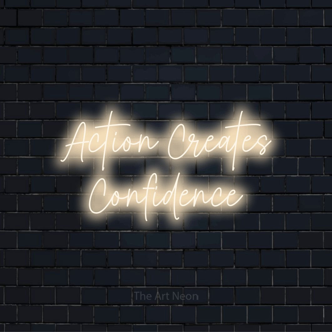 "Action Creates Confidence" LED neon sign on a black brick wall