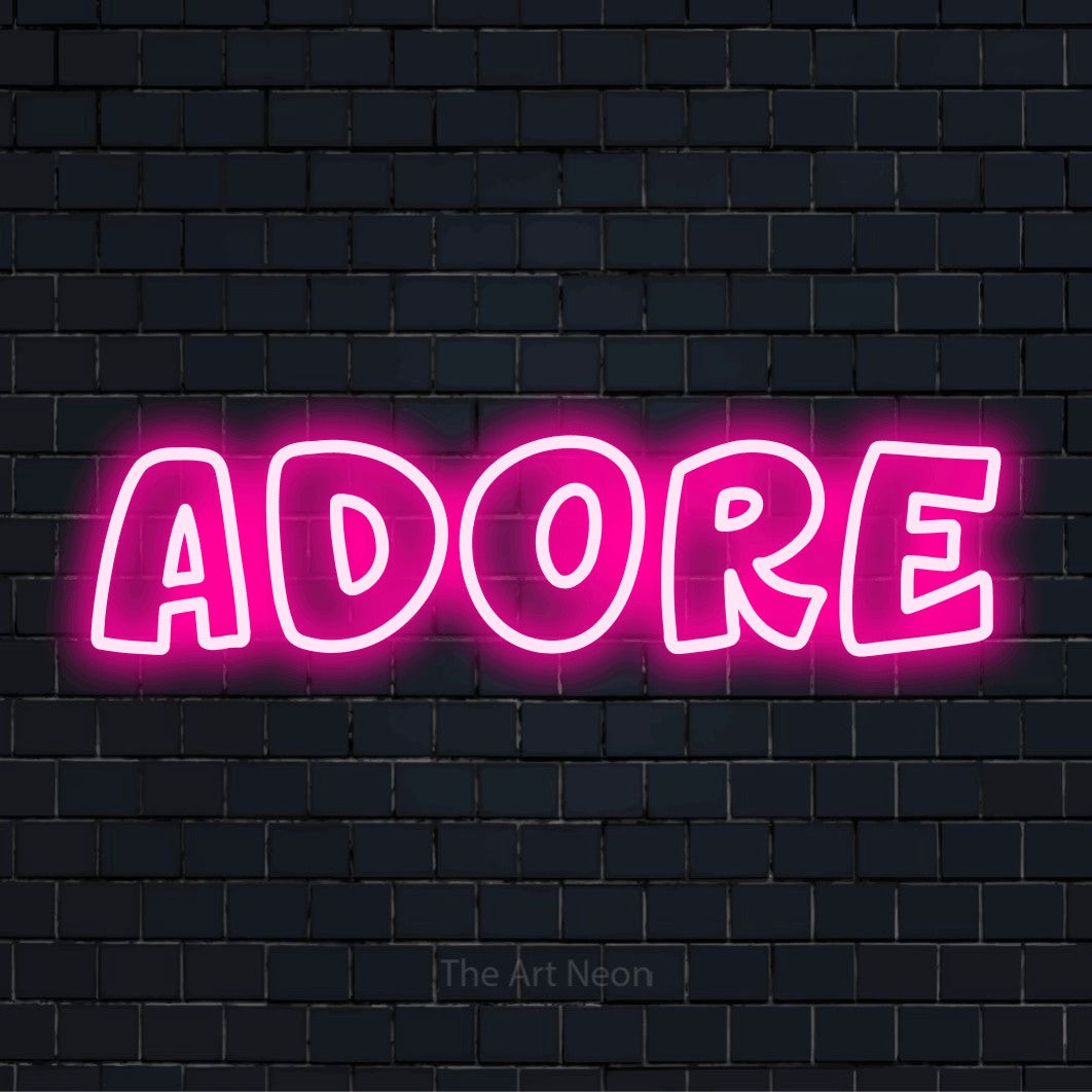 "Adore" neon text design on a black brick wall