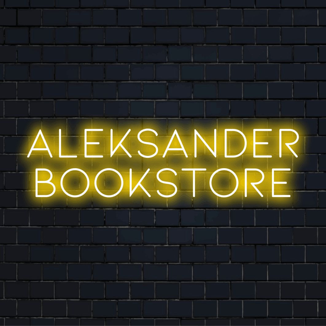 Aleksander Bookstore Personalized Neon Light with glowing lettering against brick backdrop