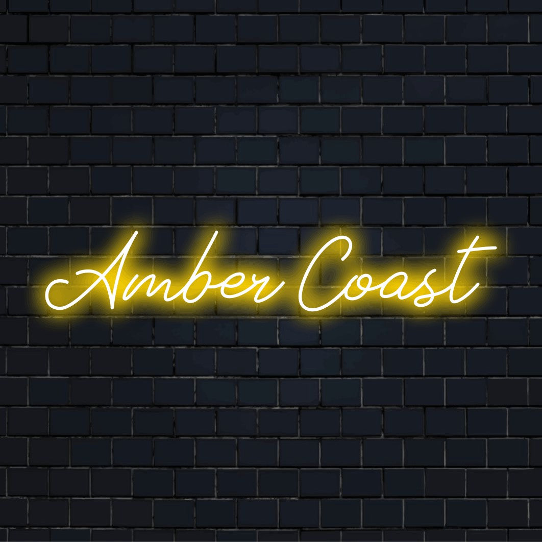 Amber Coast Neon Sign, bright neon glow against brick backdrop