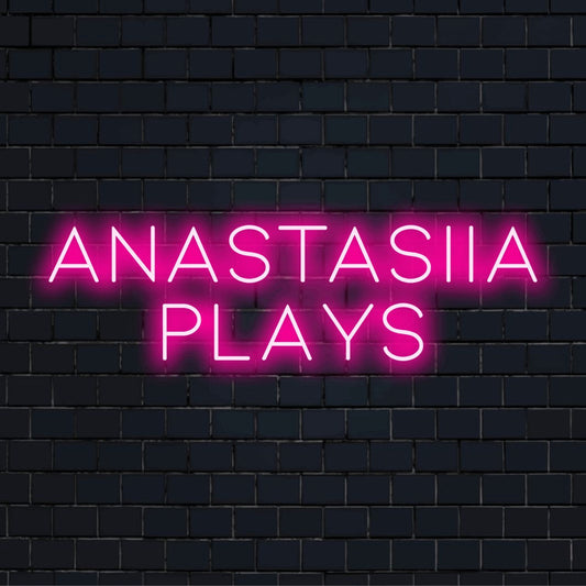 Anastasiia Plays Personalized Neon Light with glowing lettering against brick backdrop