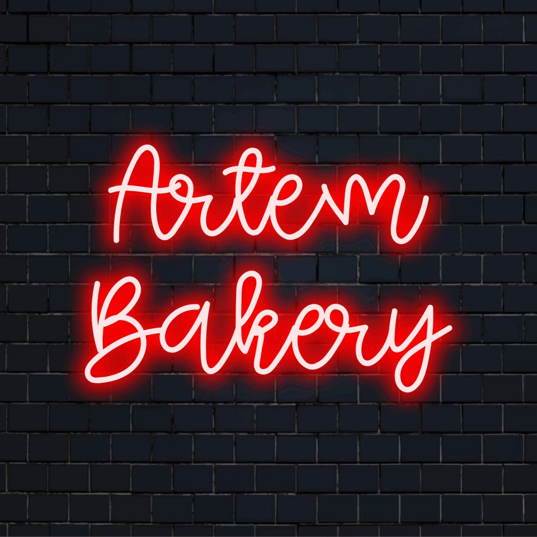Artem Bakery Personalized LED Neon Sign, bright neon lettering on dark brick wall