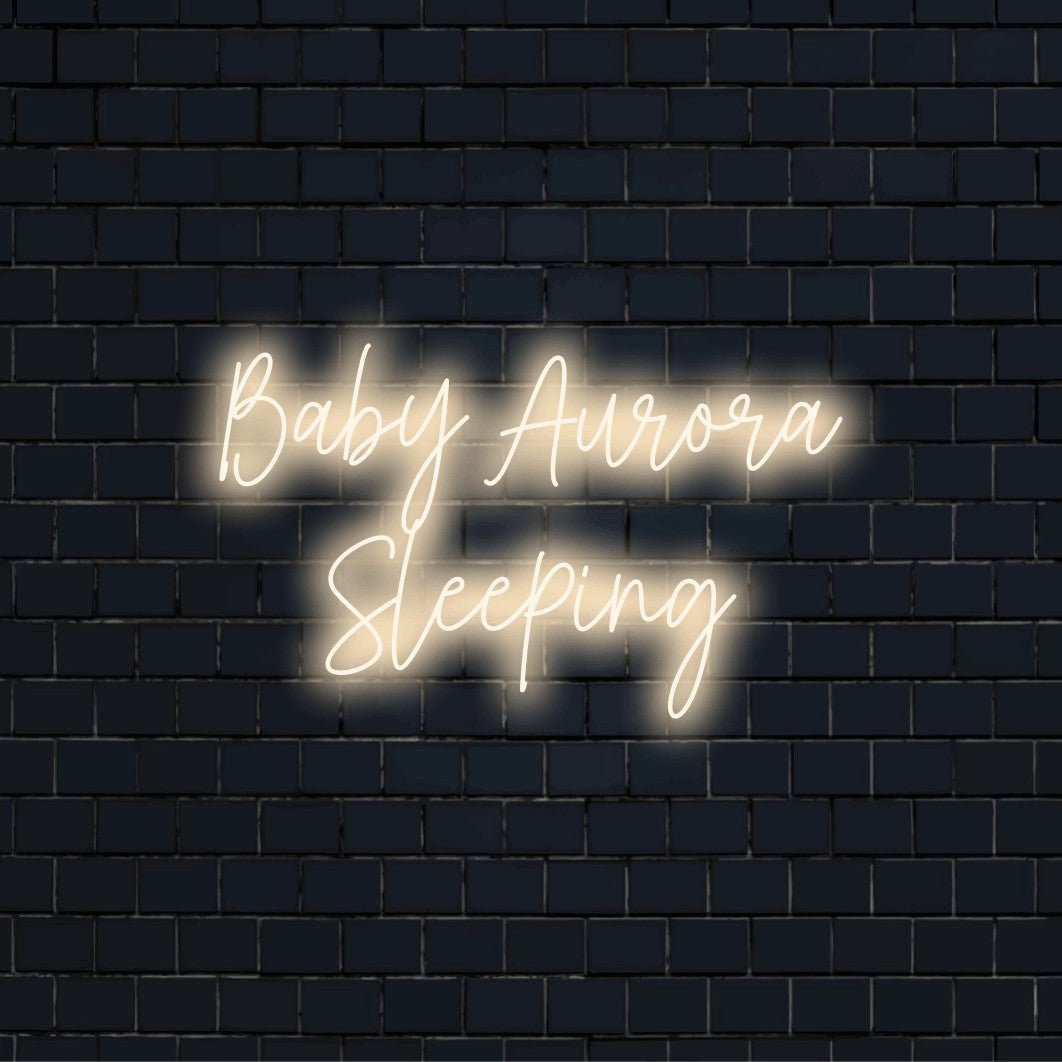 Baby Aurora Sleeping Custom Name Neon Sign, bright neon lettering on black brick background