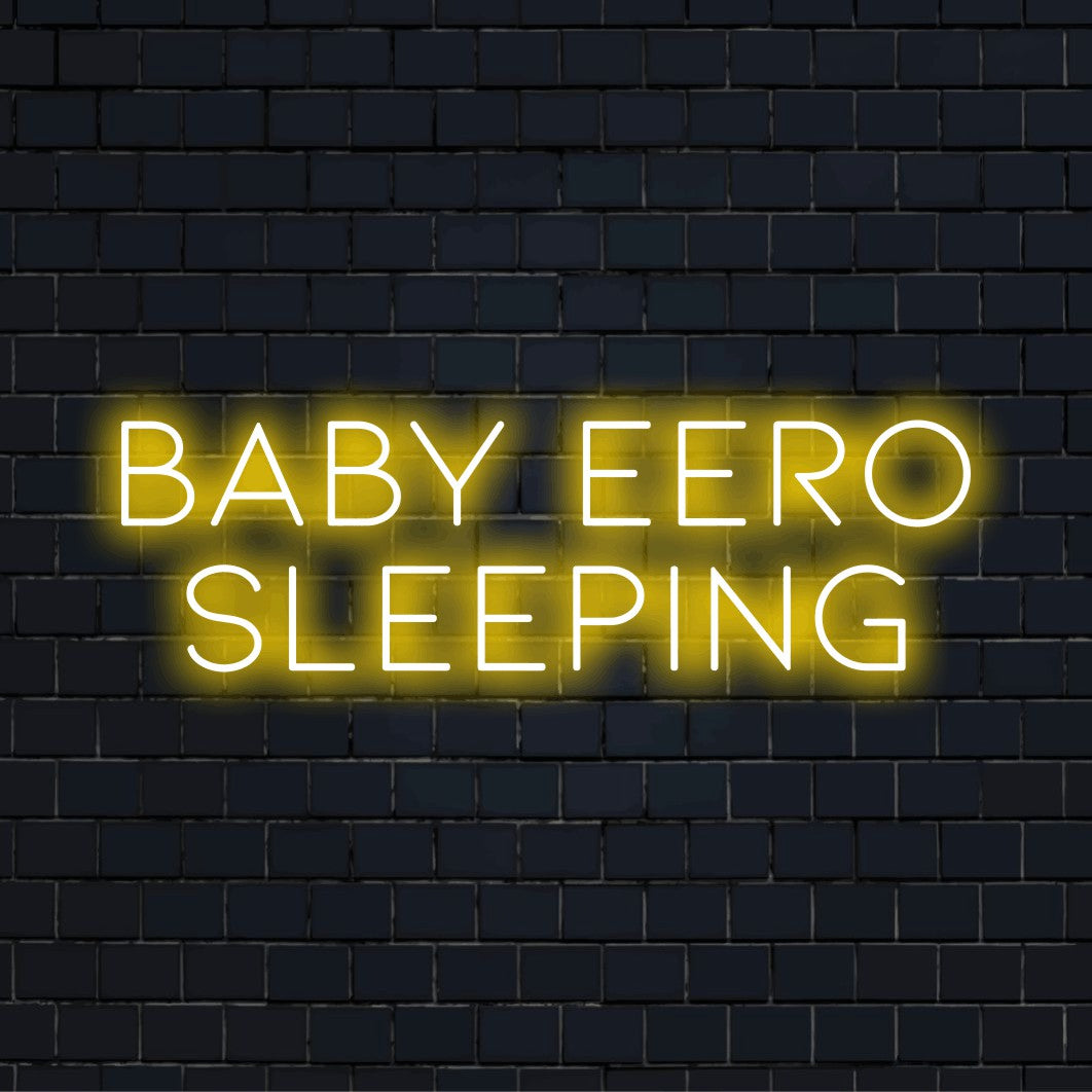Baby Eero Sleeping Custom Name Neon Sign, soft neon glow against black brick wall