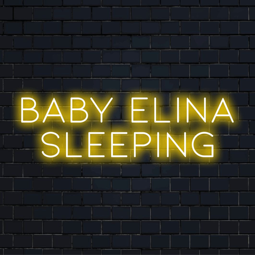 Baby Elina Sleeping Personalized LED Neon Sign, bright neon glow against brick backdrop