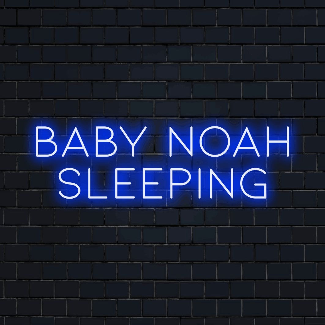Baby Noah Sleeping Custom Name Neon Sign, glowing neon text against black brick wall