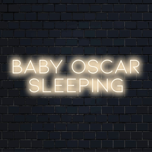 Baby Oscar Sleeping Custom Name Neon Sign, glowing wall decor against black brick wall