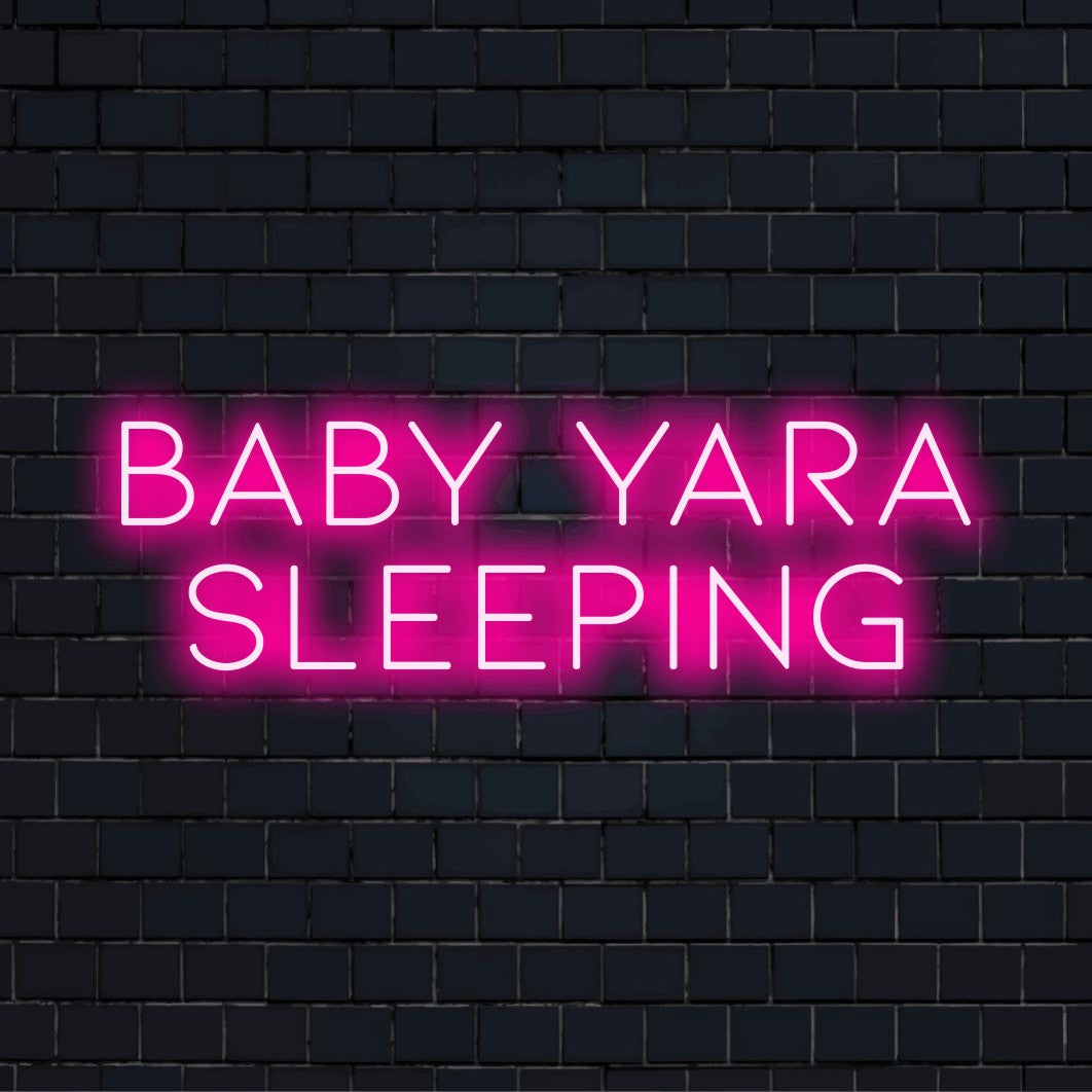 Baby Yara Sleeping Custom Name Neon Sign, bright neon glow on dark brick wall
