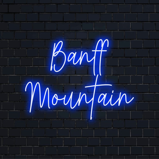 Banff Mountain Neon Light with glowing neon text on dark brick wall