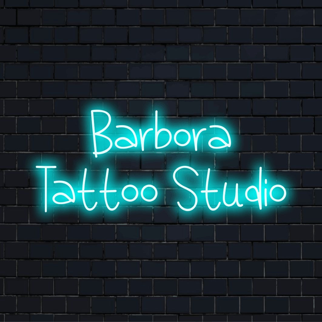 Barbora Tattoo Studio Personalized Neon Light with bright neon lettering against black brick wall