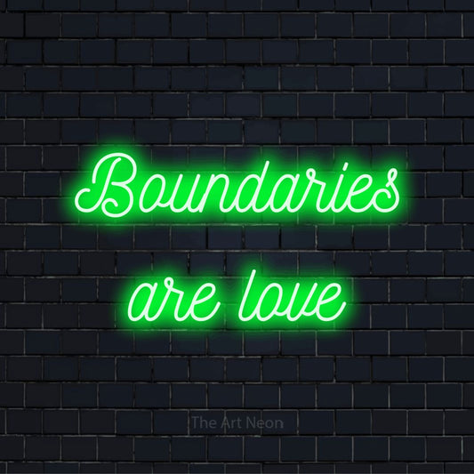 "Boundaries Are Love" script-style LED neon sign on a black brick wall