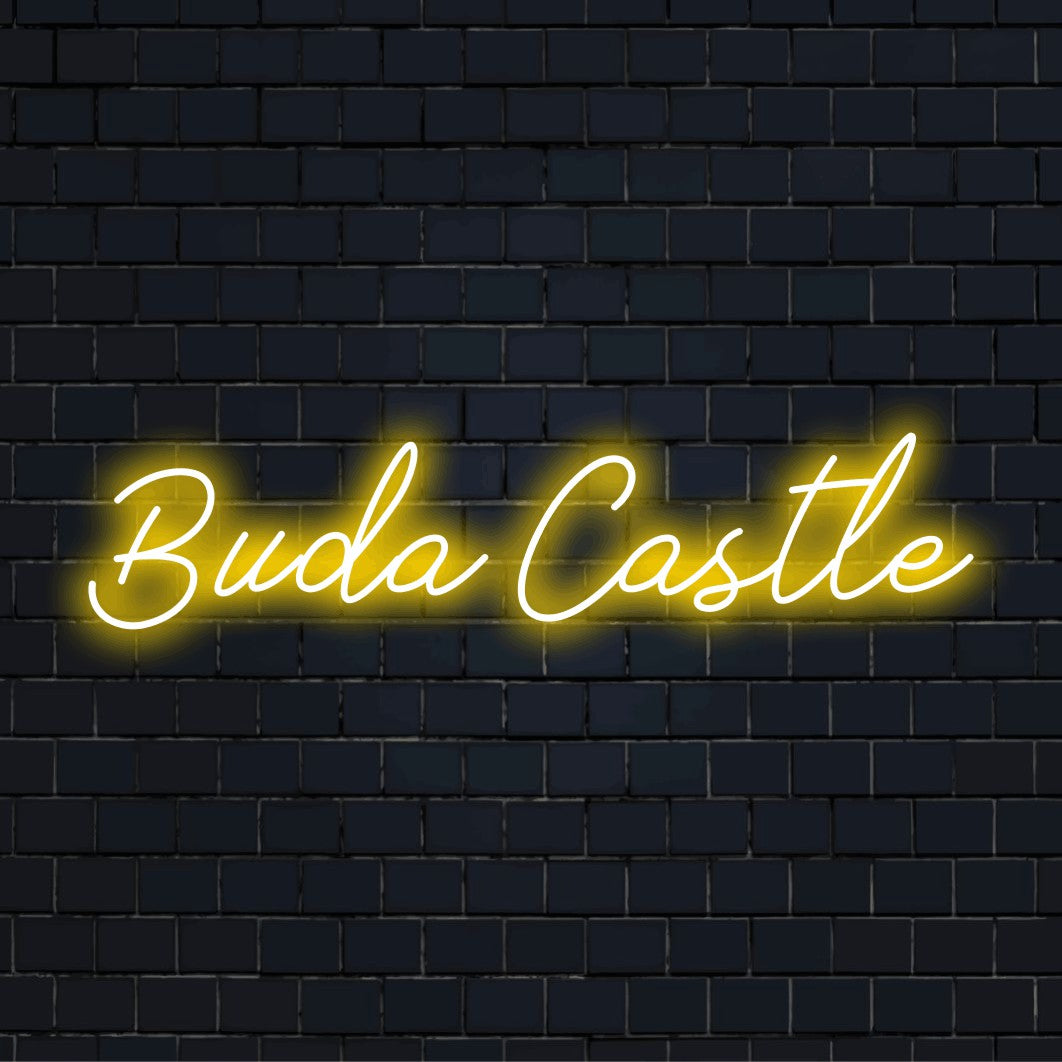 Buda Castle LED Neon Sign, glowing lettering on dark brick background