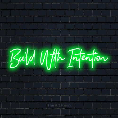 "Build With Intention" LED neon sign on a black brick wall