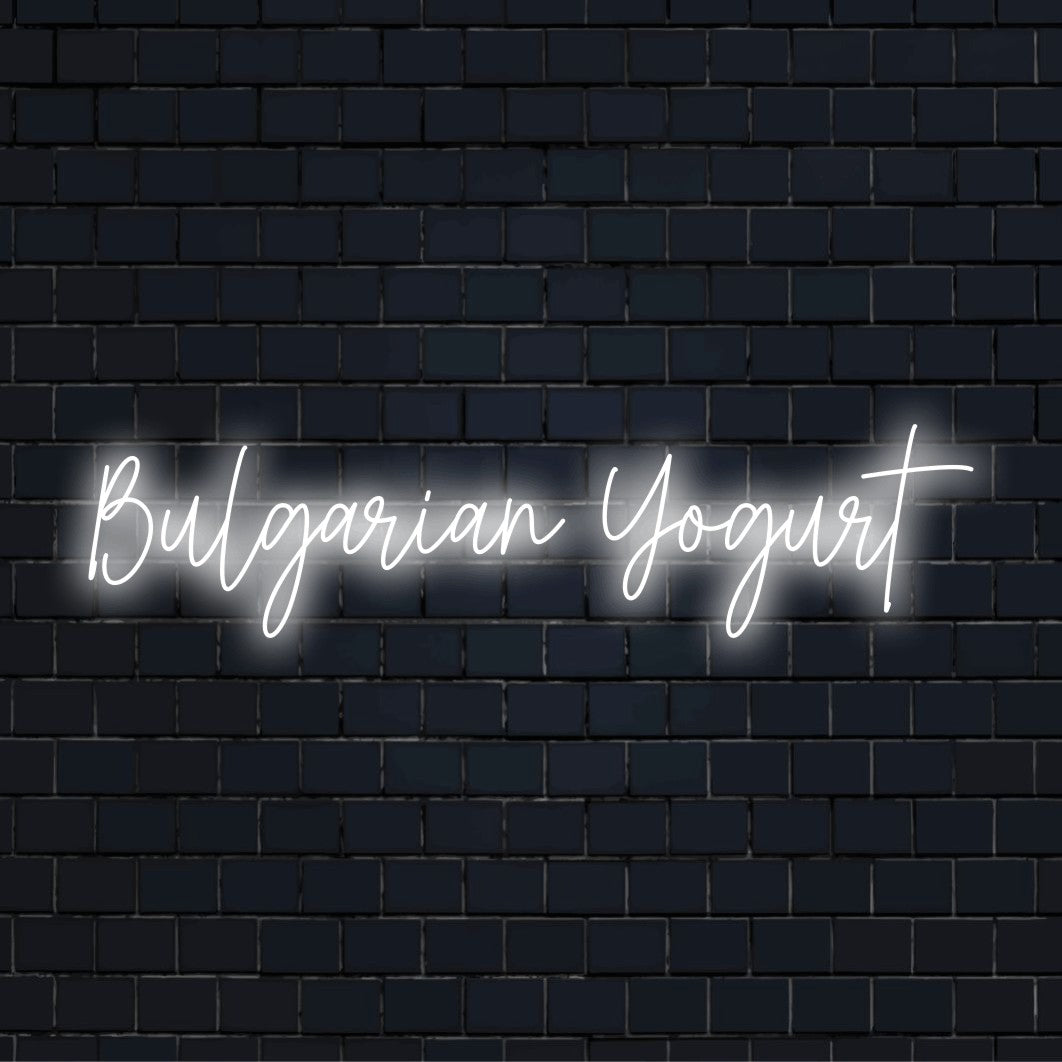 Bulgarian Yogurt Neon Sign, glowing lettering against black brick wall