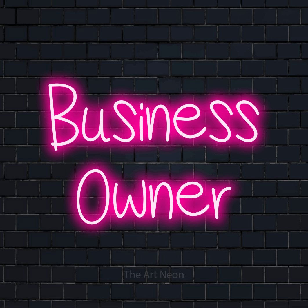"Business Owner" glowing LED neon sign on a black brick wall