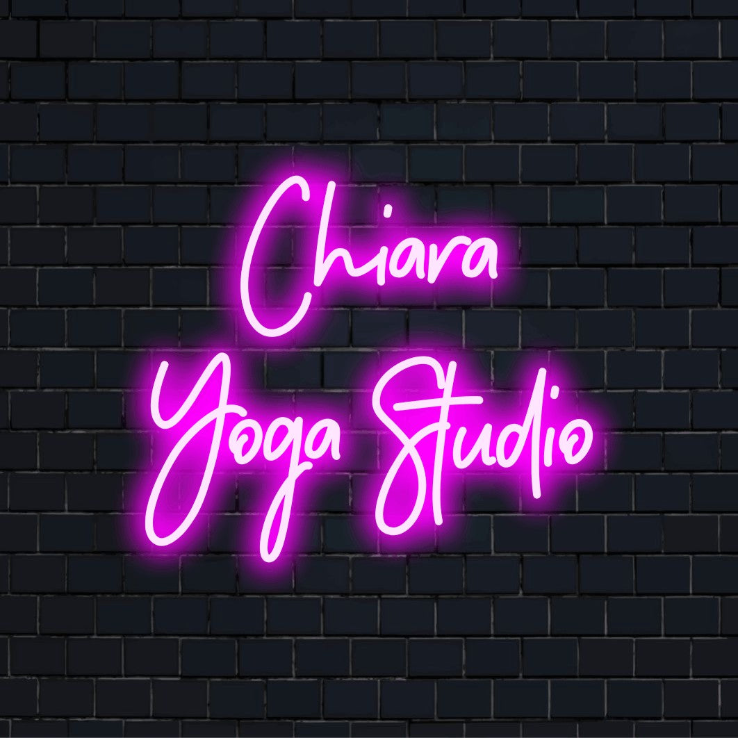 Chiara Yoga Studio Custom Name Neon Sign, neon text light against brick backdrop