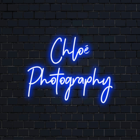 Chloe Photography Personalized LED Neon Sign, glowing lettering on dark brick wall