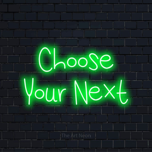 "Choose Your Next" glowing LED neon sign on a black brick wall