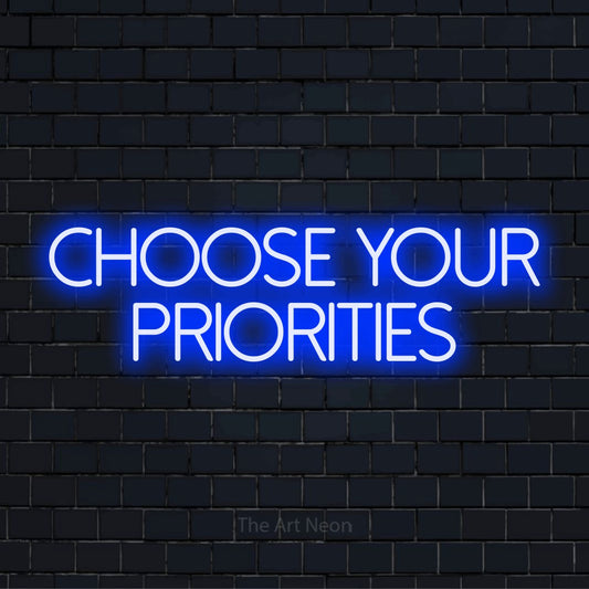 "Choose Your Priorities" LED neon sign on a black brick wall