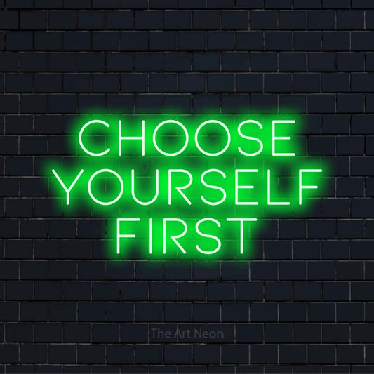 "Choose Yourself First" text design with neon effect on a black brick wall