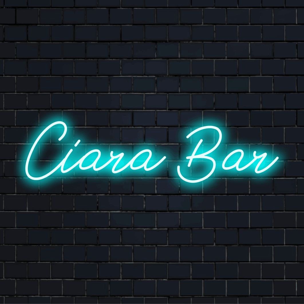 Ciara Bar Personalized Neon Light with bright neon lettering against brick backdrop