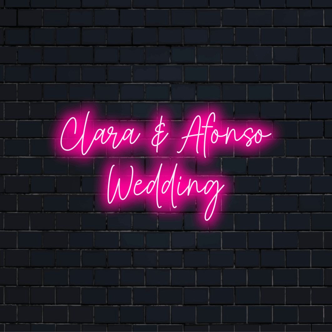 Clara _ Afonso Wedding Personalized Neon Light with glowing neon text against black brick wall