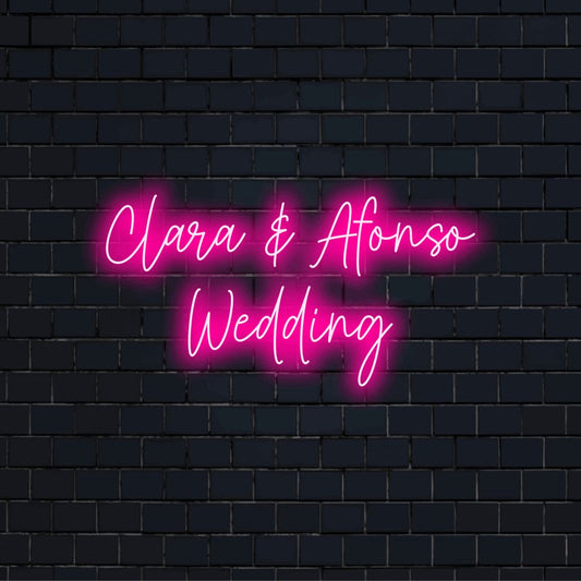 Clara _ Afonso Wedding Personalized Neon Light with glowing neon text against black brick wall