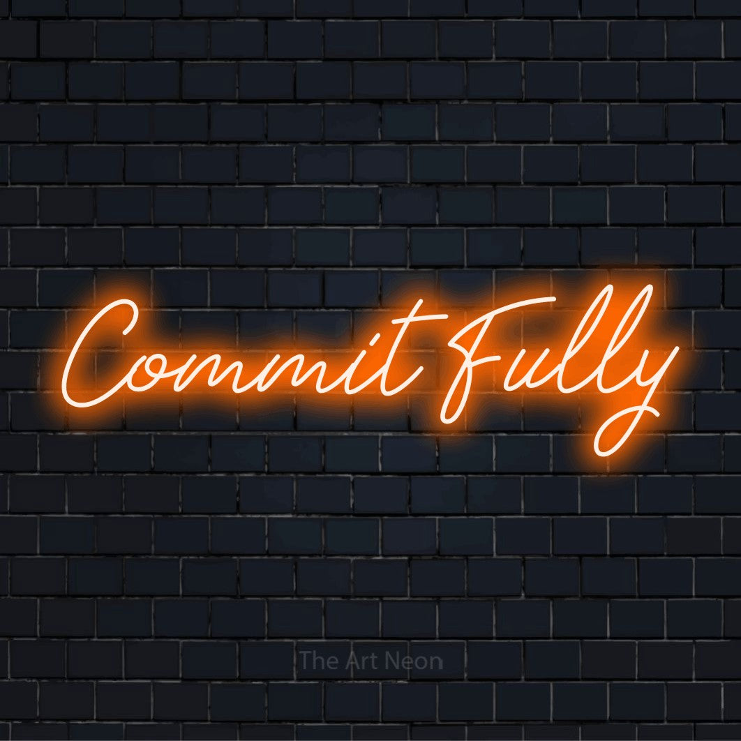 "Commit Fully" neon text design on a black brick wall