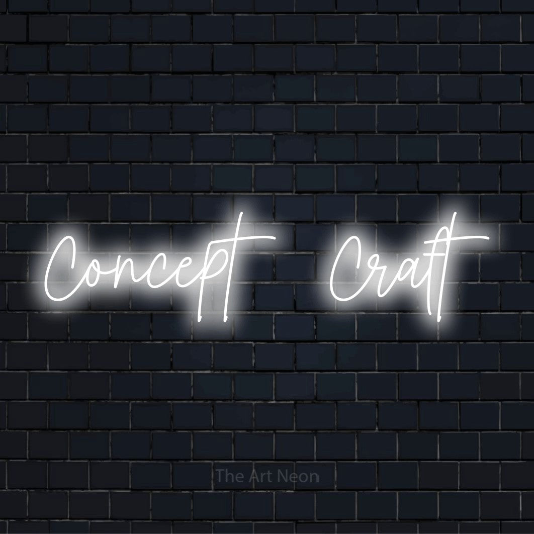 "Concept → Craft" glowing LED neon sign on a black brick wall