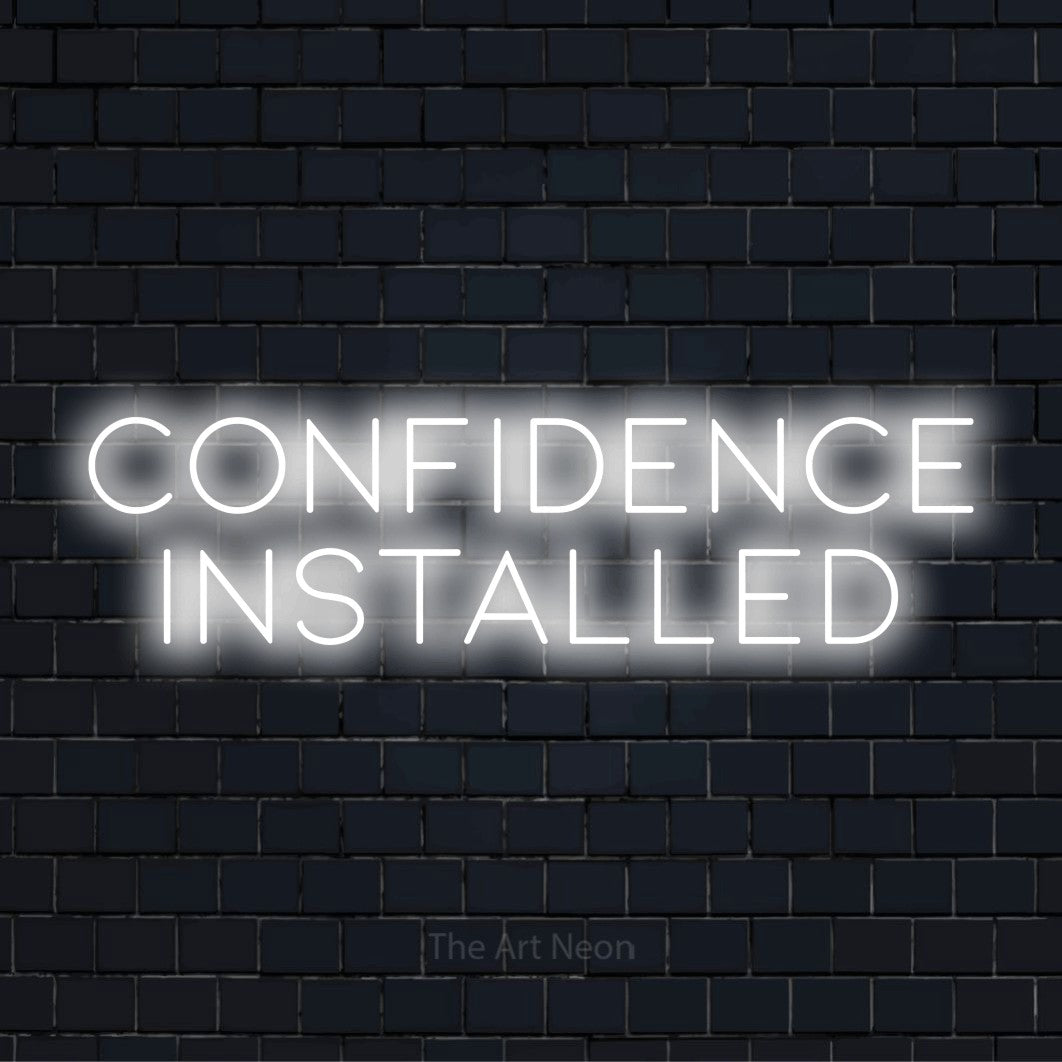 "Confidence Installed" LED neon sign on a black brick wall