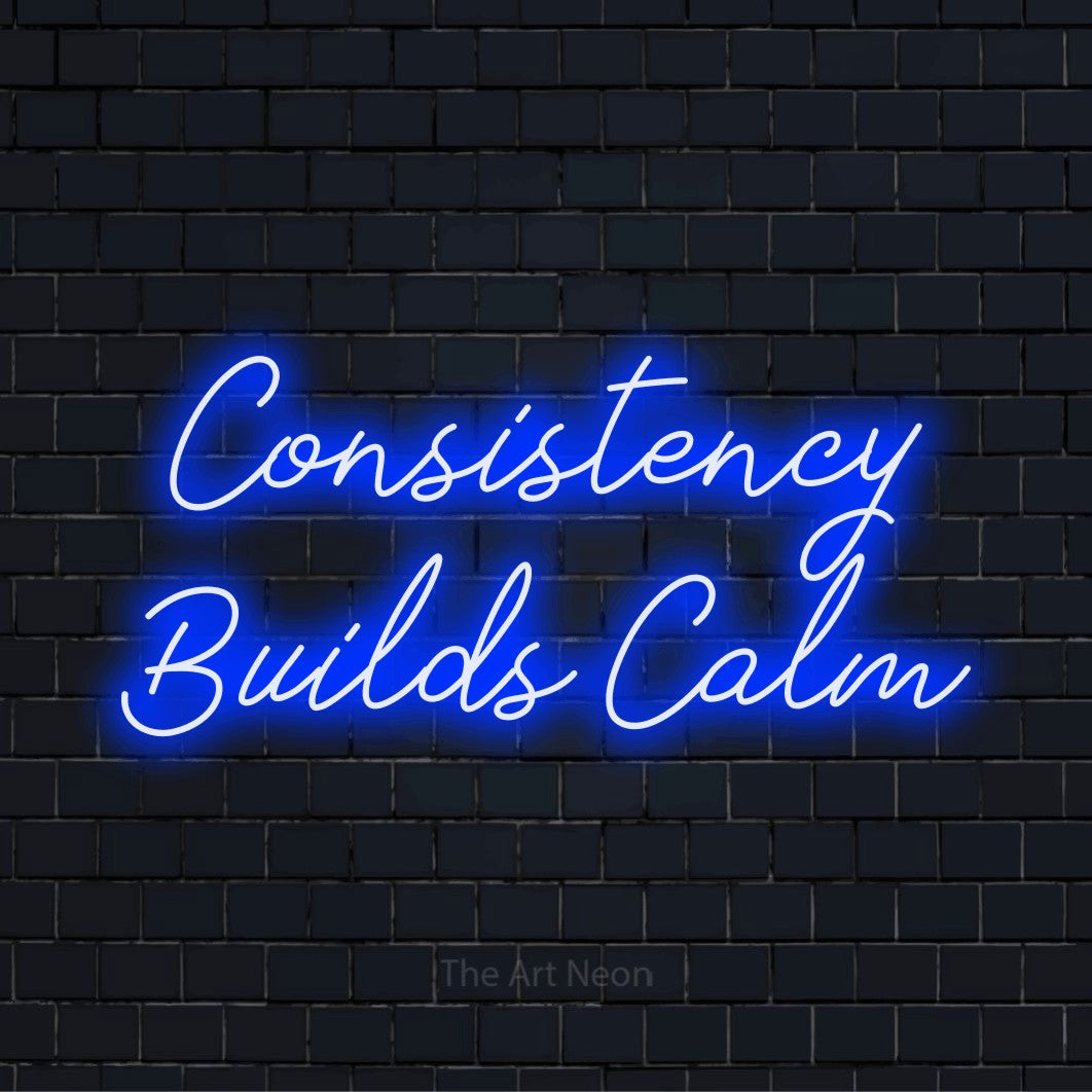 "Consistency Builds Calm" glowing LED neon sign on a black brick wall