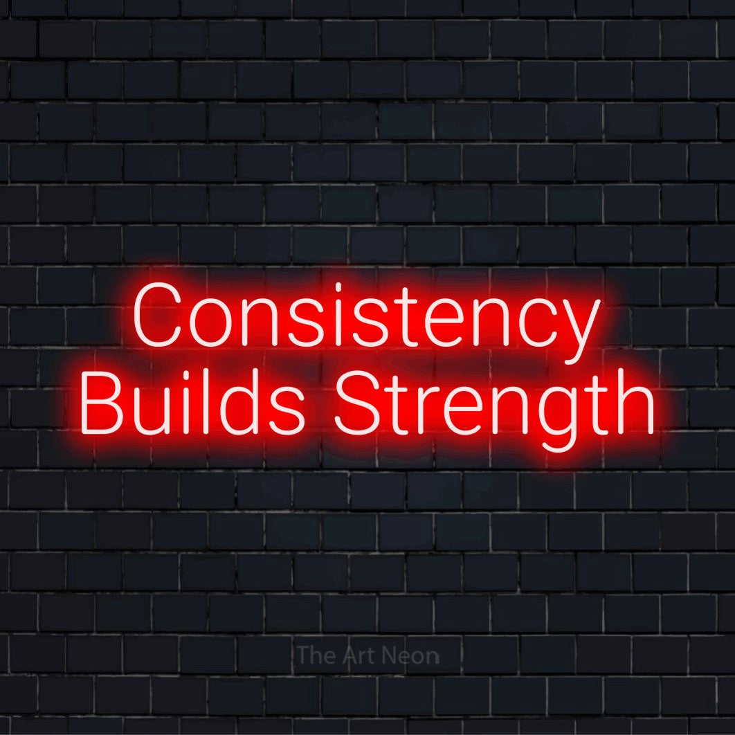 "Consistency Builds Strength" LED neon sign on a black brick wall