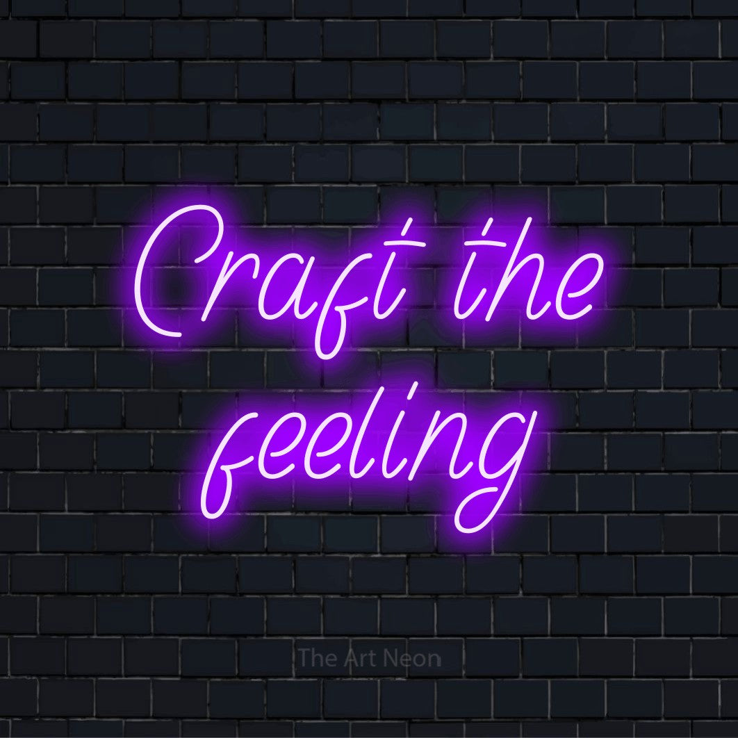 "Craft The Feeling" glowing LED neon sign on a black brick wall