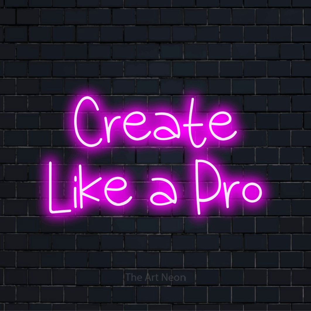 "Create Like A Pro" script-style LED neon sign on a black brick wall