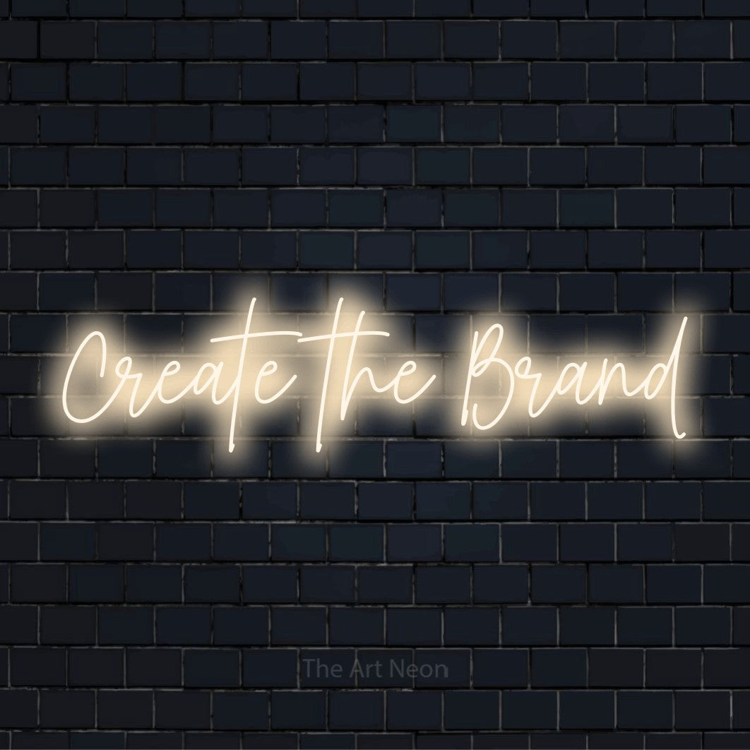 "Create The Brand" text design with neon effect on a black brick wall