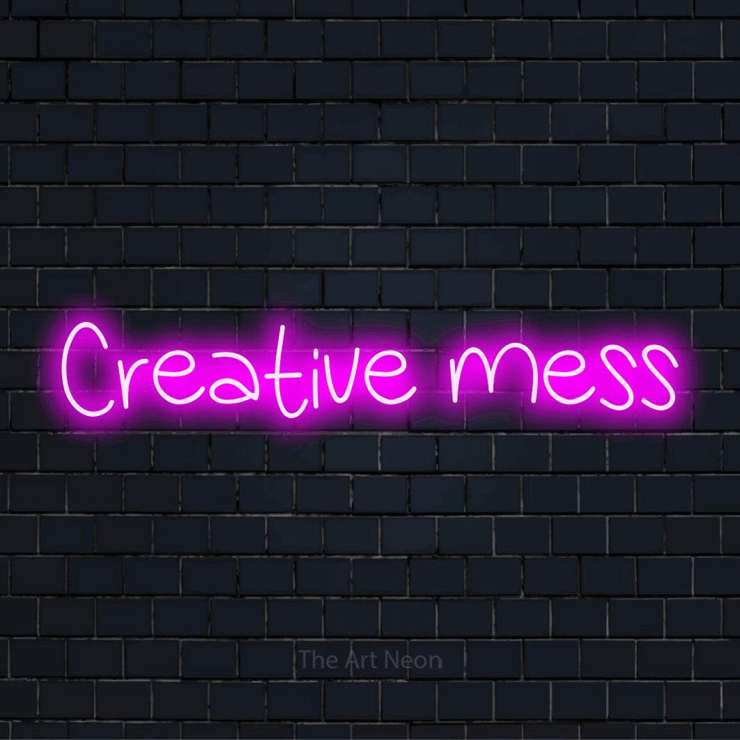 "Creative Mess" neon text design on a black brick wall