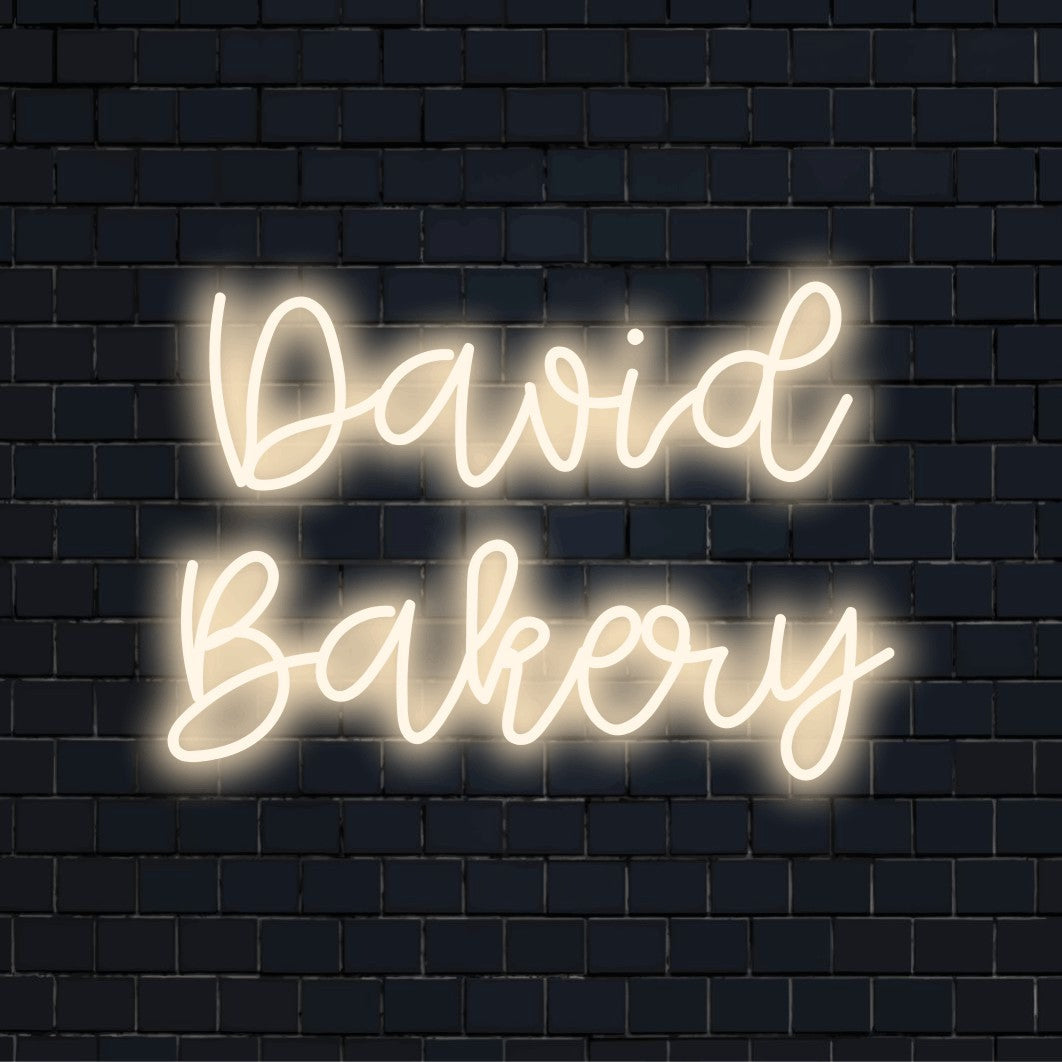 David Bakery Personalized Neon Light with glowing lettering on black brick background