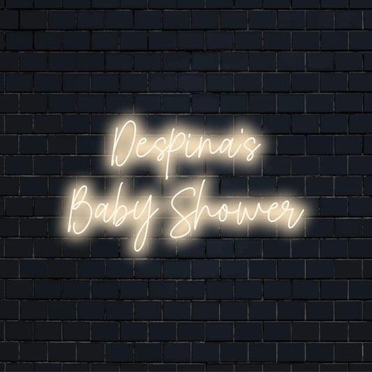 Despina_s Baby Shower Personalized LED Neon Sign, glowing lettering against black brick wall