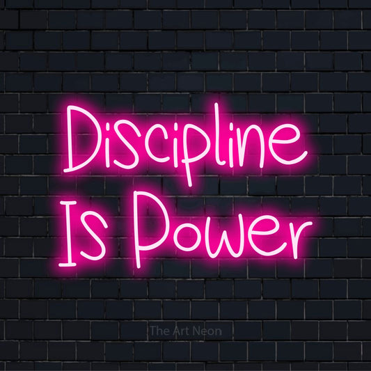 "Discipline Is Power" neon text design on a black brick wall