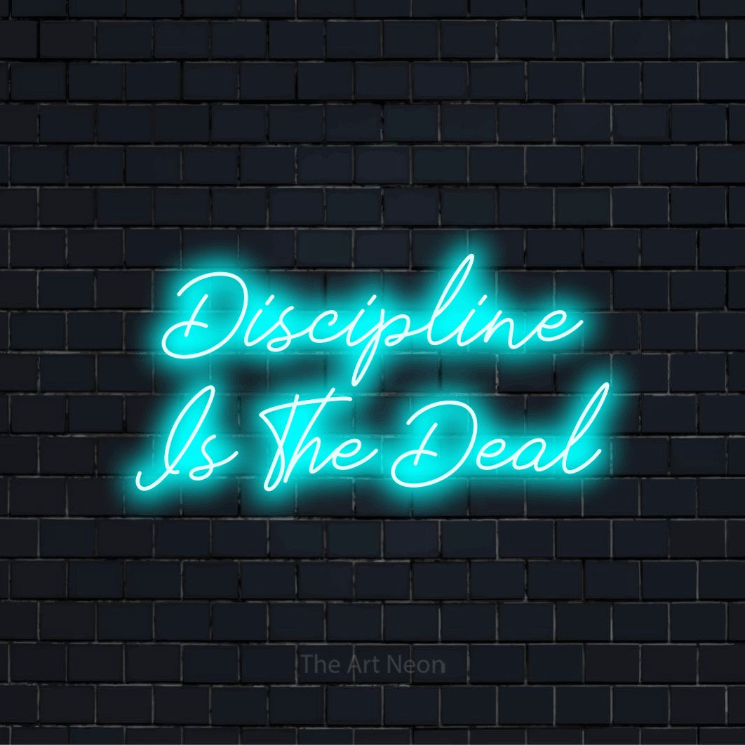 "Discipline Is The Deal" glowing LED neon sign on a black brick wall