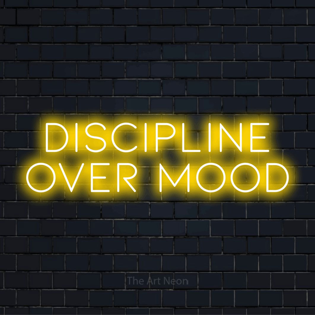 "Discipline Over Mood" glowing LED neon sign on a black brick wall